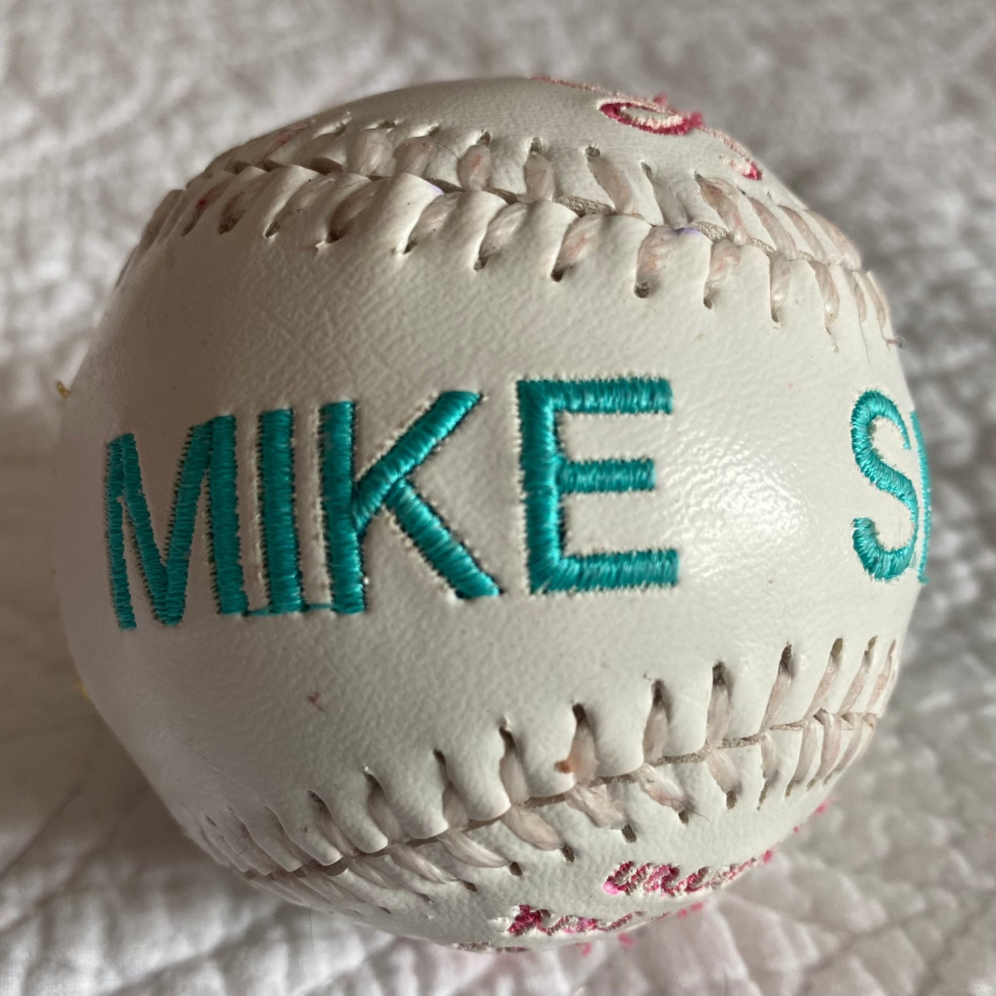 Custom embroidered baseball or softball.  Done in your chosen colors with red or white  lacing